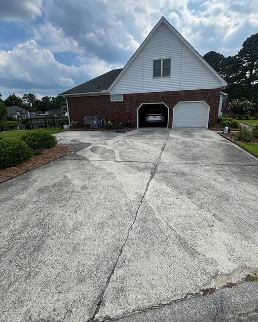 Same driveway before washing, streaked gray and dark